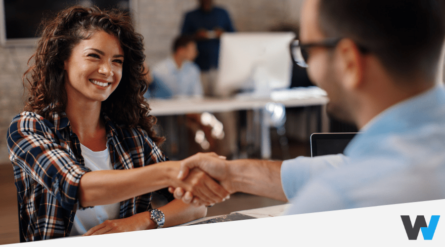 business woman shaking hand of her partner