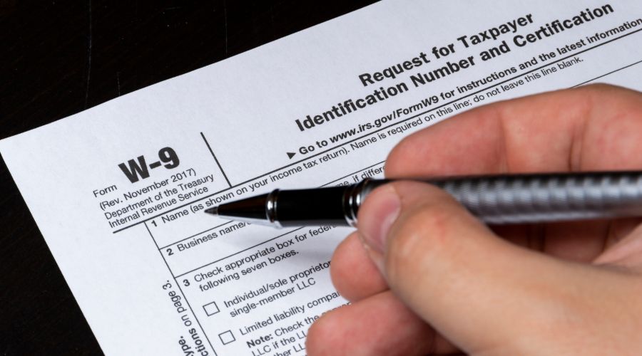 person filling out form w-9