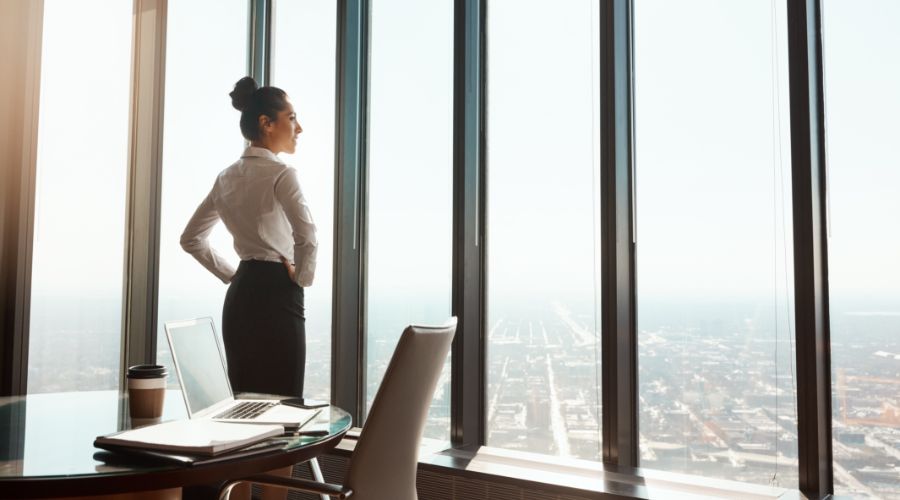 Professional woman looking out her office window